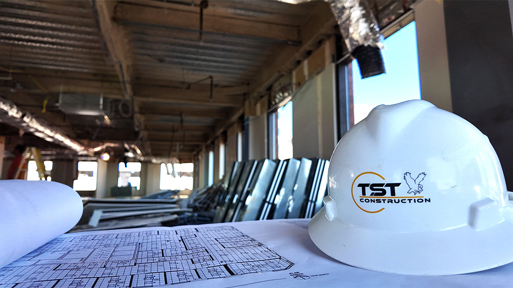 Hard hat and plans inside a construction site