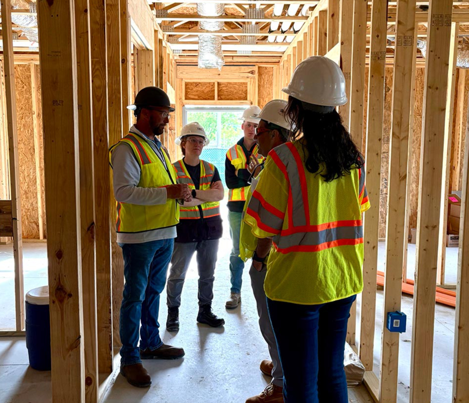workers talk in construction interior